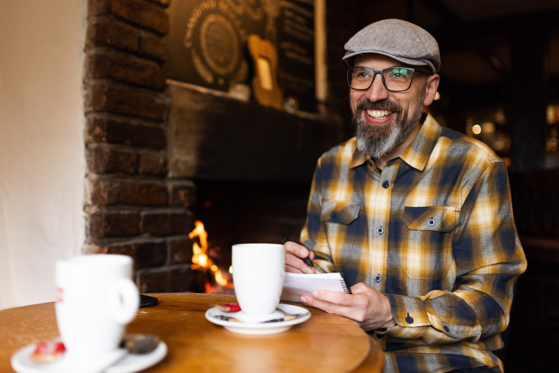 James taking notes in a pub