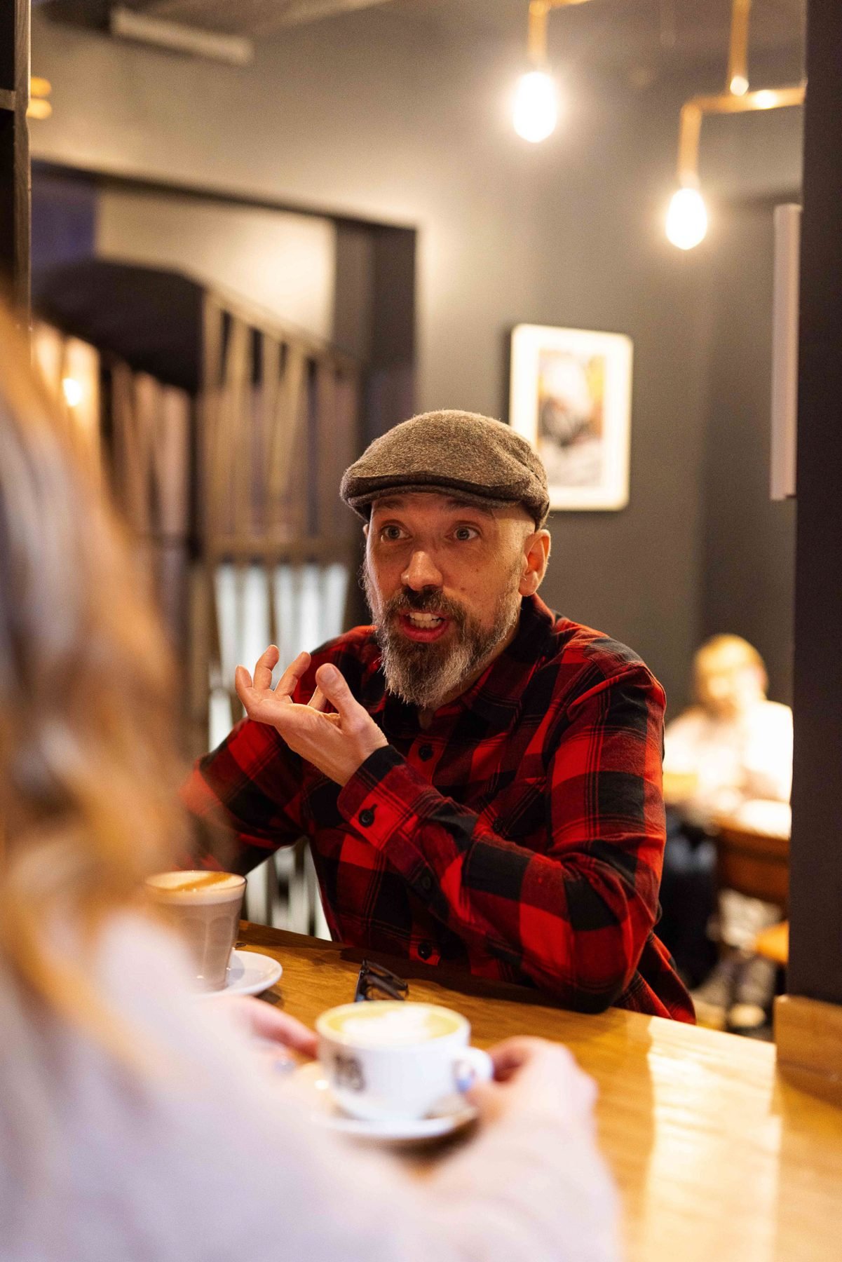 James working with a client in a coffee shop