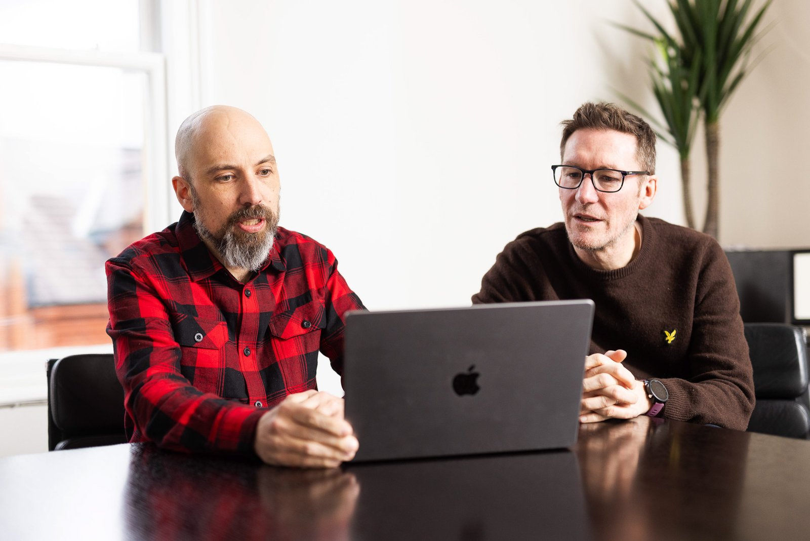 James and Garry working together at a laptop