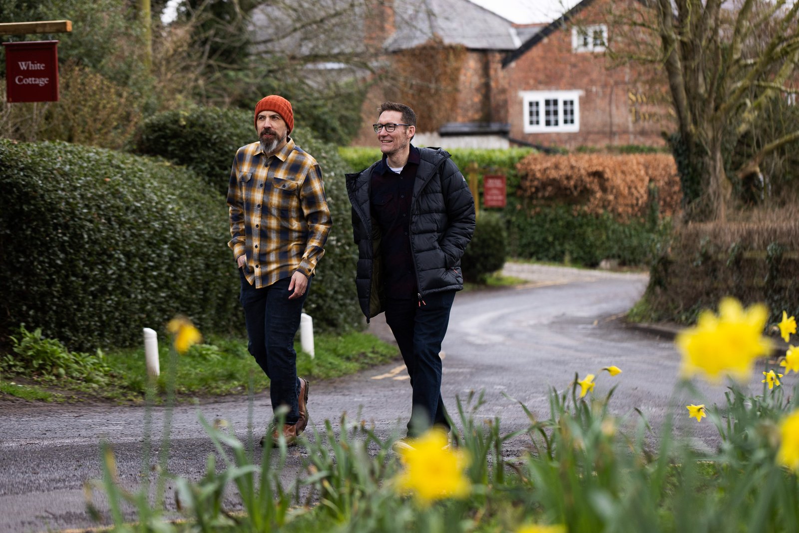 James and Garry walking and talking together in a village
